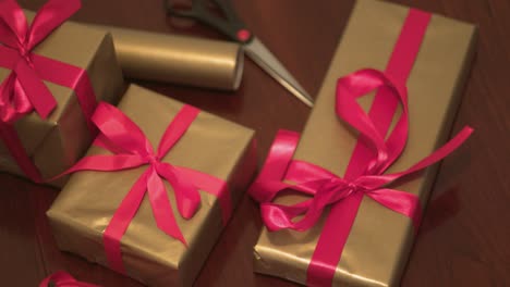 Christmas-Gifts-Gold-Wrapped,-Red-Ribbon