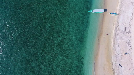 Amazing-top-down-view-of-someone-walking-on-Lombok-Beach-toward-the-water