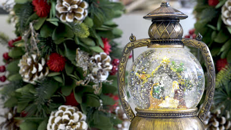 Snowglobe-with-child-in-the-manger-and-Christmas-background