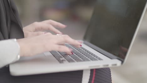Close-Up-Shot-Of-Woman-Typing-On-Keyboard-Whilst-Working-Outside-,-In-Slowmotion---Ungraded