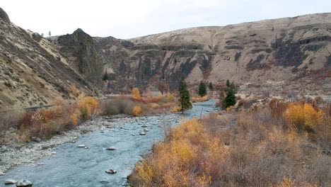Ariel-drone-footage-of-a-rugged-river-valley-in-fall