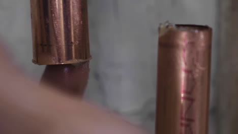 Extreme-closeup-of-a-man's-finger-applying-flux-to-a-copper-pipe-before-soldering