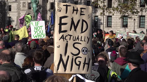 UK-October-2018---A-handmade-banner-hovering-over-a-crowd-of-protestors-says,-“The-end-is-actually-nigh”