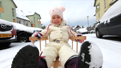 A-little-girl-is-on-a-snow-sleigh
