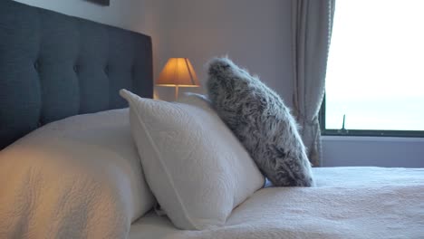 SLOWMO---Luxury-modern-boutique-hotel-room-double-queen-size-bed-with-ocean-sea-view---rotate-view---CLOSE-UP
