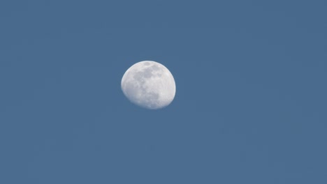 The-moon-glowing-against-a-light-blue-sky