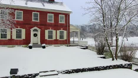 Descending-and-revealing-an-aerial-view-of-a-Georgian-mansion-in-Lancaster,-Pennsylvania,-beautiful-historic-house-with-red-brick-facade,-Rock-Ford-Plantation-in-Winter,-travel-concept,-historic-site