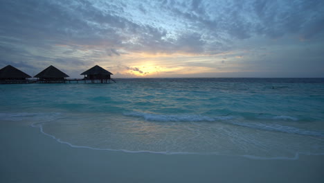 After-The-Sunset-Footage-of-Maldives-Hotel-Bungalows-on-Water-With-Colorful-Sky-and-Beach-With-Clear-Indian-Ocean