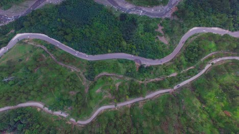 Zigzag-road-top-view,-Kahmir,-India,-Traffice-is-going-on,-Big-forest-and-green-trees,-tow-zigzag-road-and-a-river-view-from-maximum-hieght