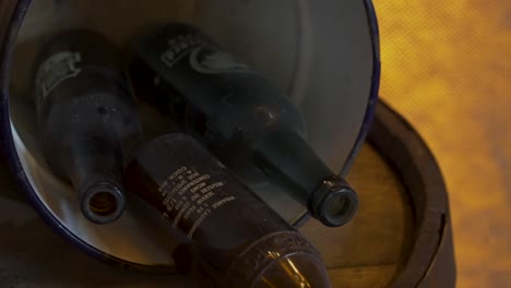 Slow-reveal-of-old-bottles-in-a-bucket