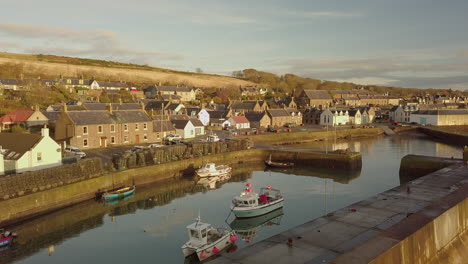 Aerial-footage-of-Johnshaven-harbour-and-town-at-sunrise,-Aberdeenshire,-Scotland