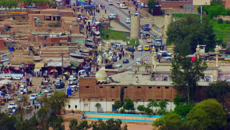 Peshawar,-Pakistan,-Mountain-pass-connecting-the-Pak-Afghan-border,-Aerial-shot-of-the-road,-showing-Mosque-and-main-highway-over-the-houses
