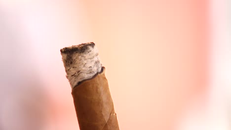 Extreme-close-up-of-someone-holding-and-smoking-a-cigar-in-the-Caribbean
