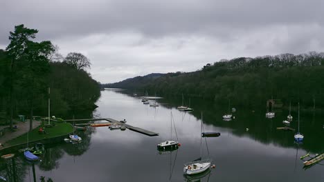 Beautiful-aerial-view,-footage-of-Rudyard-Lake-in-the-Derbyshire-Peak-District-Nation-Park,-popular-holiday,-tourist-attraction-with-boat-rides-and-water-sports-on-off,-peaceful,-calm-water