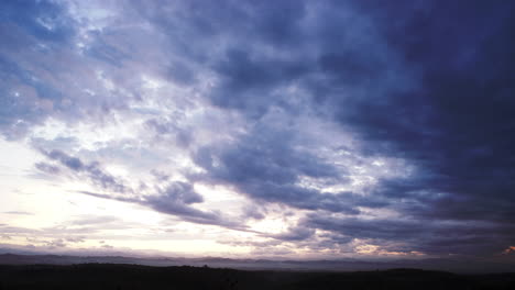 Time-Lapse-of-Morning-Cloudy-Sky-Form-Dark-to-Light-Over-Looking-Mountain-Range-Panorama-Background