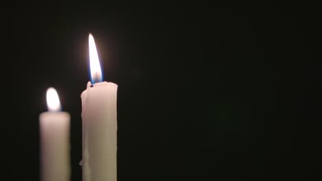 Two-white-Candles-burning-in-slow-motion