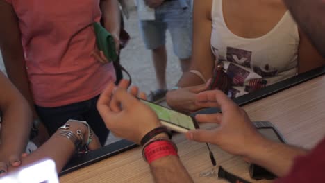 Close-shot-of-a-woman-making-an-nfc-payment-with-its-wristband-on-a-music-festival