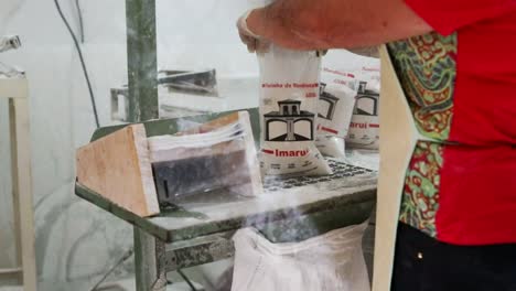 Flour-mill-worker-fills-bags-with-freshly-processed-flour-in-slow-motion