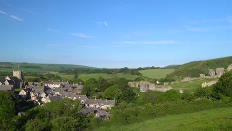 Slow-panning-shot-of-Corfe-village-and-castle-early-morning,-Isle-of-Purbeck,-Dorset,-England