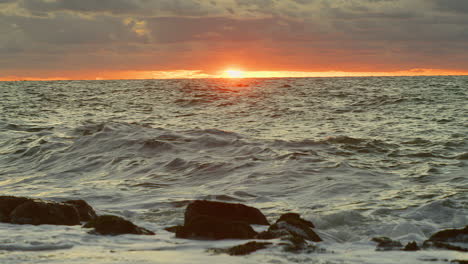 Northsea-waves-hitting-a-dyke-at-sunset