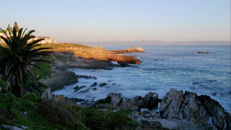 Timelapse-of-waves-rolling-in-to-bay-with-very-rocky-shore-in-the-beautiful-Hermanus,-South-Africa