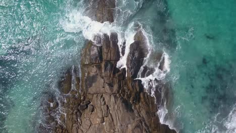 Bird's-eye-view-of-waves-crashing-against-rocky-Australian-coastline