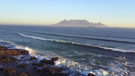Aerial-view-of-sunset-on-Cape-Town-beach-with-table-mountain-in-the-background