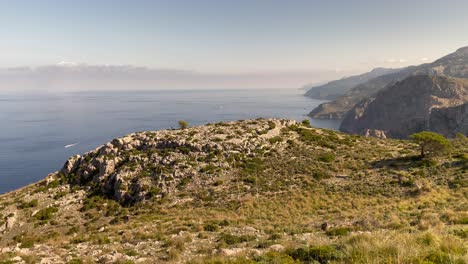View-Over-Mountain-Range-And-Sea-At-Fondal-De-Ses-Basses,-Mallorca,-Spain,-Tilt