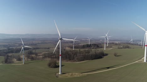 Green-energy-wind-turbines-creating-electricity-in-Czech-Republic---aerial-slowmo-shot
