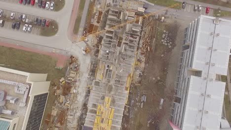 straight-down-shot-of-a-construction-site-with-cranes,-drone