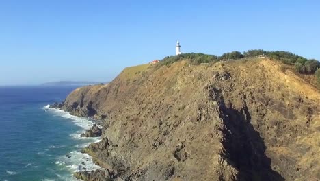 Aerial-drone-shot-flying-along-Cape-Byron-cliffs-towards-lighthouse