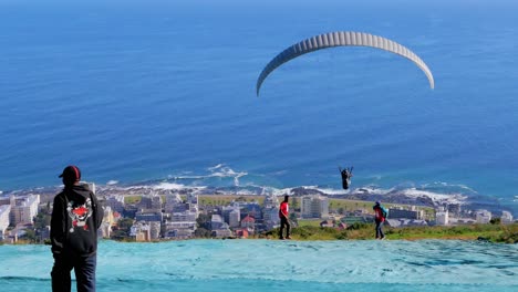Tandem-paragliding-off-of-Signal-Hill-in-Cape-Town,-South-Africa
