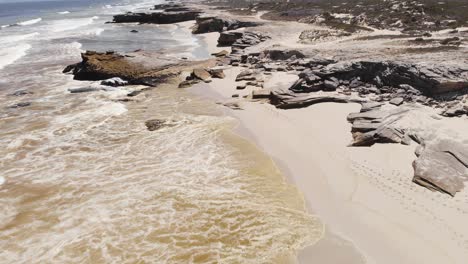 AERIAL:-Red-Algae-in-the-water-on-South-African-Beach-next-to-garden-route