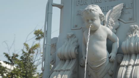 A-Cherub-With-Wings-Spits-Water-From-A-Fountain