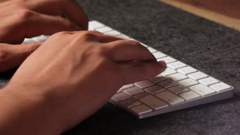 Männliche-Latino-hände,-Die-Mit-All-Seinen-Fingern-Schnell-In-Eine-Weiße-Drahtlose-Tastatur-Tippen