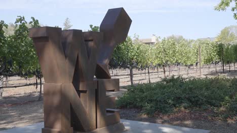 A-static-shot-of-a-sculpture-in-Napa-valley-yountville-in-front-of-a-vineyard