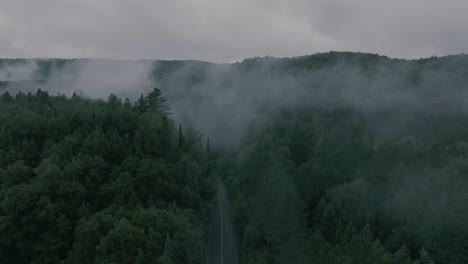 Drone-flying-through-a-beautiful-foggy-mountain-top-landscape