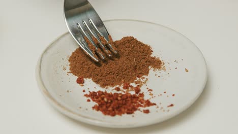 Blended-paprika-and-parsley-on-a-plate-with-white-background