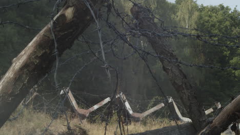 Abandoned-border-with-barbed-wire-and-barricades-shrouded-in-smoke