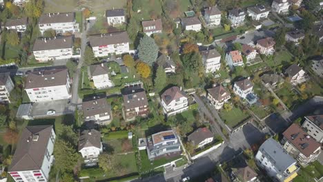 Drone-panning-aerial-view:-Residential-neighborhood-in-a-Lausanne:-Houses-,buildings-and-trees