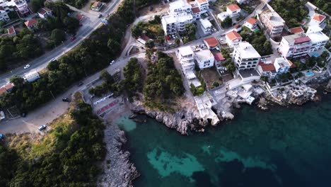 Modern-apartment-buildings-on-shore-of-Adriatic-sea-with-secluded-beach,-aerial