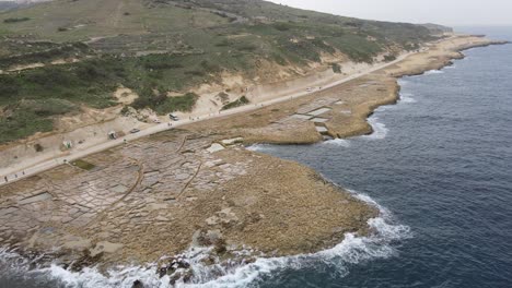 Aerial-drone-shot-flying-above-salt-pans-and-beautiful-Mediterranean-coast-of-Gozo-Island-in-Malta