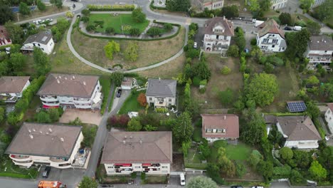 Aerial-view,-Tilt-up-with-drone:-Residential-area-in-Lausanne-town:-Houses,-buildings-and-gardens
