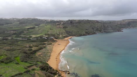 Beautiful-landscape-aerial-view-over-beach-in-Ramla-bay,-Island-of-Gozo,-Malta