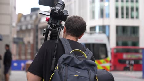 Videographer-walking-through-London-on-his-way-to-get-footage