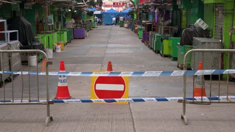 A-sign-and-barrier-prohibiting-access-warning-the-public-of-a-locked-down-area-to-contain-the-spread-of-the-Coronavirus-variant-outbreak-in-Hong-Kong