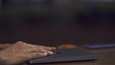Cinematic-shot-of-hands-typing-a-message-on-a-laptop-and-then-closing-the-computer