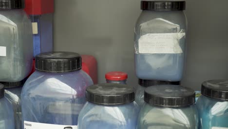 Plastic-container-full-of-blue-pigment-color-in-laboratory