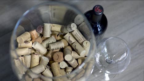 SLOMO:-A-pile-of-corks,-wine-bottle-and-glass
