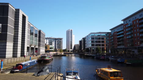 Static-Shot-of-Leeds-Dock-Mixed-Development-in-Yorkshire,-UK-on-a-Sunny-Summer’s-Day-with-the-Yellow-Water-Taxi-Entering-into-Shot